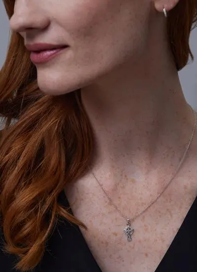 Close up shot of red haired model wearing Sterling Silver Small Celtic Cross Pendant